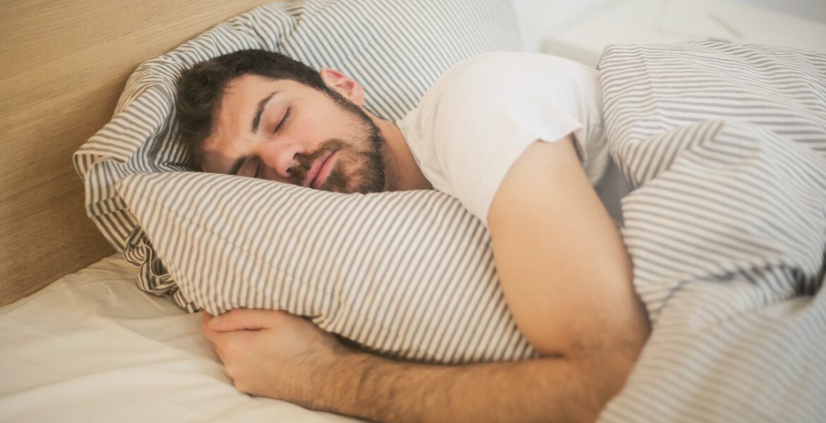 Man is asleep in his bed