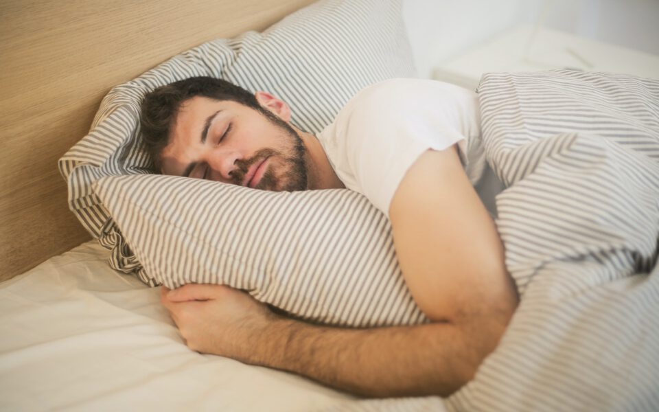 Man is asleep in his bed