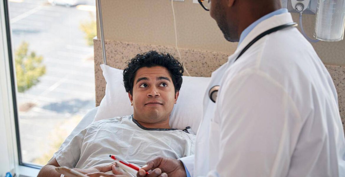 Young man in hospital being treated by the doctor