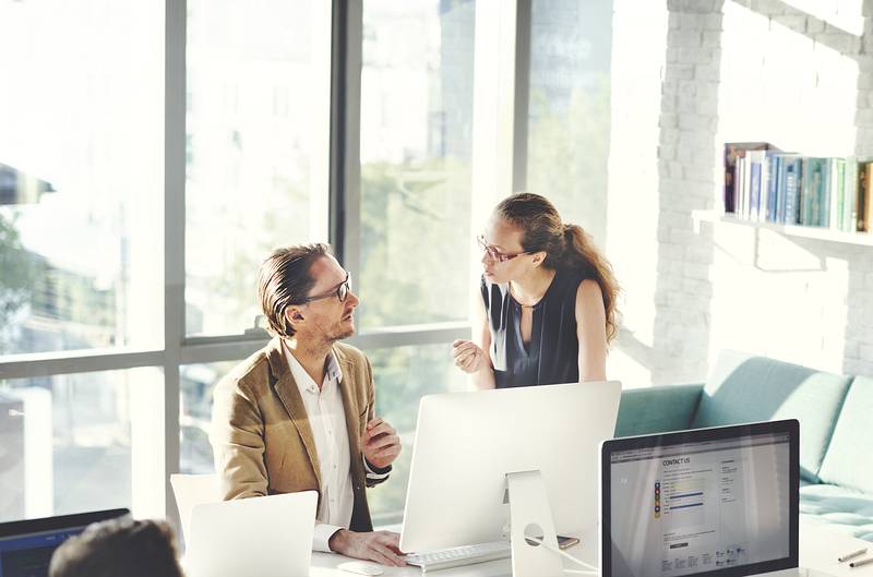 Man and woman are choosing the best stock photos